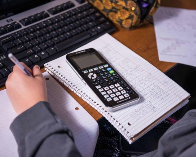 Close-up of student working on math homework